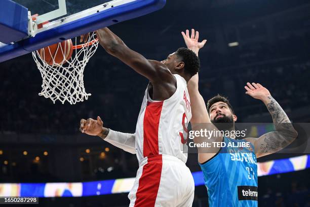 Canada's RJ Barrett scores next to against Slovenia's Ziga Dimec during the FIBA Basketball World Cup quarter-final match between Canada and Slovenia...