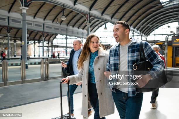 young couple at the train station - newcastle stock pictures, royalty-free photos & images
