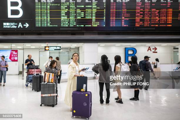 Tourists walk in the arrival hall of Narita International Airport in Narita, Chiba Prefecture, outside Tokyo on September 7, 2023.