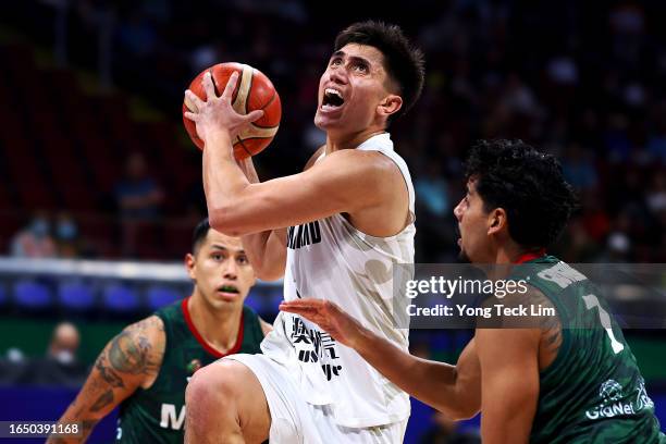 Reuben Te Rangi of New Zealand is fouled on a drive to the basket by Jorge Gutierrez of Mexico in the fourth quarter during the FIBA Basketball World...