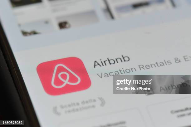 An Airbnb logo displayed on a smartphone is seen in L'Aquila, Italy, on september 9th, 2023. Some metropolises and countries are imposing...