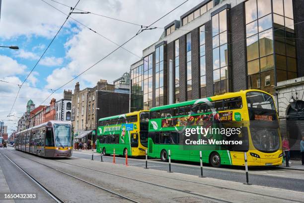 busses and tramway on abbey street lower in dublin - transportation stock pictures, royalty-free photos & images