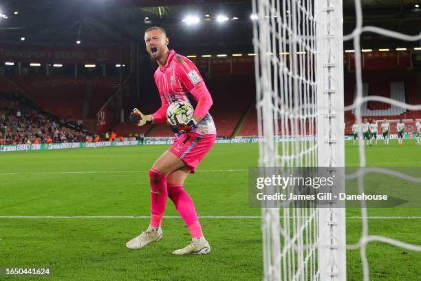 Lukas Jensen of Lincoln City celebrates after saving a penalty in the shootout during the Carabao Cup Second Round match between Sheffield United and...