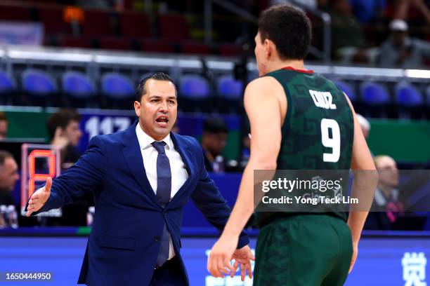 Pako Cruz of Mexico celebrates with head coach Omar Quintero after sinking a three-pointer in the fourth quarter during the FIBA Basketball World Cup...