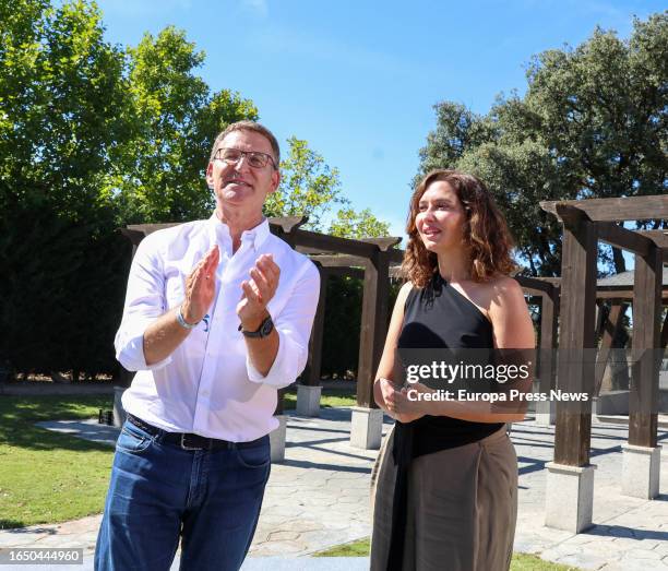 The president of the PP, Alberto Nuñez Feijoo, and the president of the Community of Madrid, Isabel Diaz Ayuso, applaud on their arrival at an event...