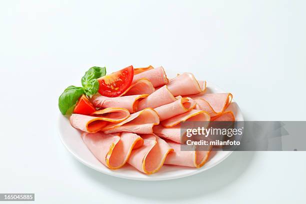 slices of smoked ham on a plate - sliced ham stock pictures, royalty-free photos & images