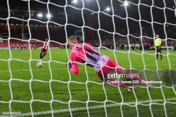 Lukas Jensen of Lincoln City saves the penalty of Benie Traore of Sheffield United in the shootout during the Carabao Cup Second Round match between...