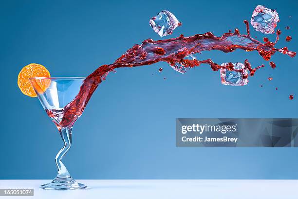 wet and wild tropical drink spilling - tangerine martini stock pictures, royalty-free photos & images