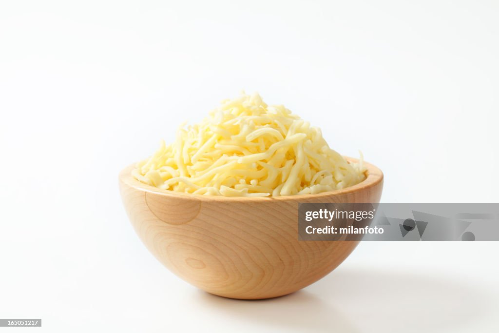 Wooden bowl with grated cheese