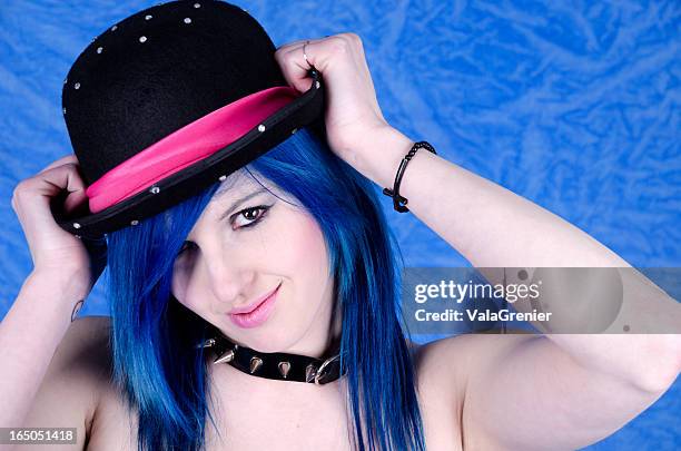 playful teen girl holding hat - spike collar stock pictures, royalty-free photos & images