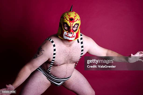 man in wrestling pose with mask and one piece. - wrestler stock pictures, royalty-free photos & images