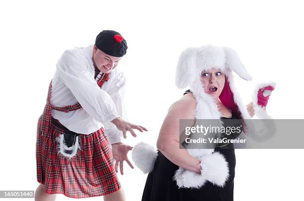 mad scot chasing easter bunny. - easter bunny man stock pictures, royalty-free photos & images