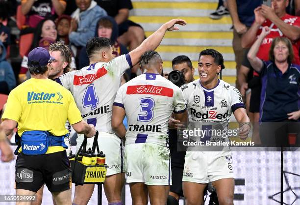 Sualauvi Faalogo of the Storm celebrates with team mates after scoring a try during the round 27 NRL match between the Brisbane Broncos and Melbourne...