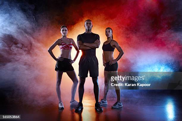 portrait of 3 athletes - posizione sportiva foto e immagini stock