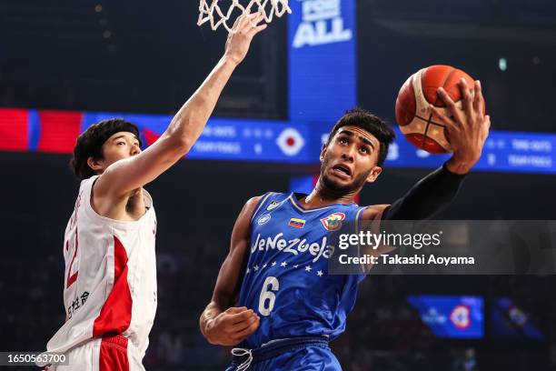 Garly Sojo of Venezuela drives to the basket against Yuta Watanabe of Japan during the FIBA Basketball World Cup Classification 17-32 Group O game...