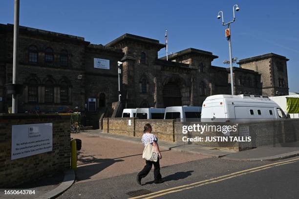 Pedestrian passes the stone walls of HM Prison Wandsworth in the late summer sunshine in south London on September 7 a day after terror suspect,...