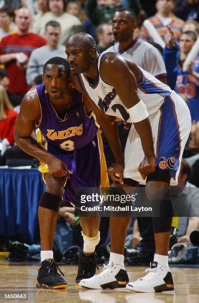 Michael Jordan of the Washington Wizards stands alongside Kobe Bryant of the Los Angeles Lakers during the game at the MCI Center on November 8, 2002...