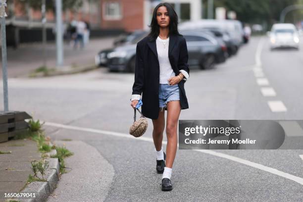 Sophia Estelle Göhler seen wearing gold necklace and bracelets, white knit striped top, black oversized blazer jacket, light blue denim shorts, Gucci...