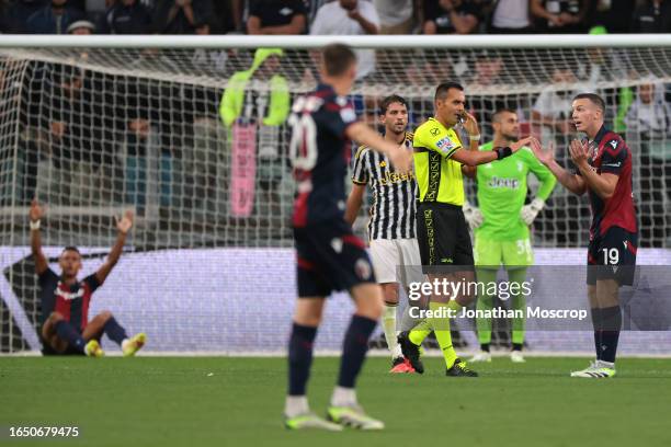 Dan Ndoye of Bologna FC raises his arms. As team mate Lewis Ferguson appeals to the Referee Marco Di Bello for a penalty during the Serie A TIM match...