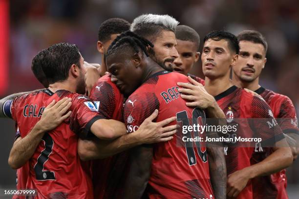 Olivier Giroud of AC Milan celebrates with team mates after scoring a first half penalty to give the side a 2-1 lead during the Serie A TIM match...