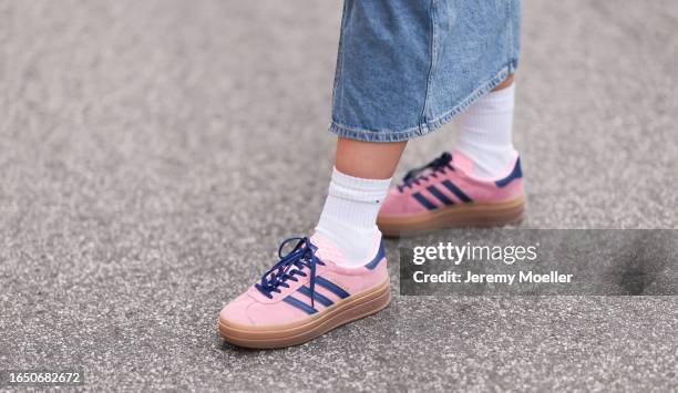 Xelia Blom seen wearing light blue long denim skirt, white cotton socks, Adidas Gazelle Bold pink sneakers, on August 25, 2023 in Hamburg, Germany.