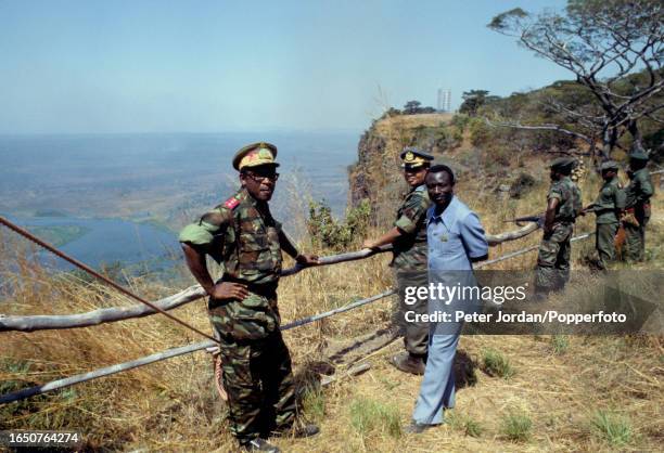 President of Zaire Mobutu Sese Seko stands on left with senior military and government officials during a visit to the city of Kolwezi following...