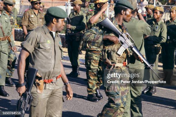 Troops from the Zaire Armed Forces guard President of Zaire Mobutu Sese Seko as he visits the city of Kolwezi following fighting between FLNC rebels...