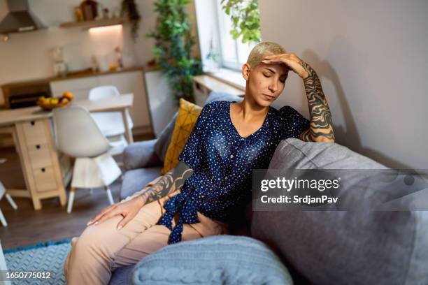 young woman suffers from headache - tattoo sleeve woman stock pictures, royalty-free photos & images