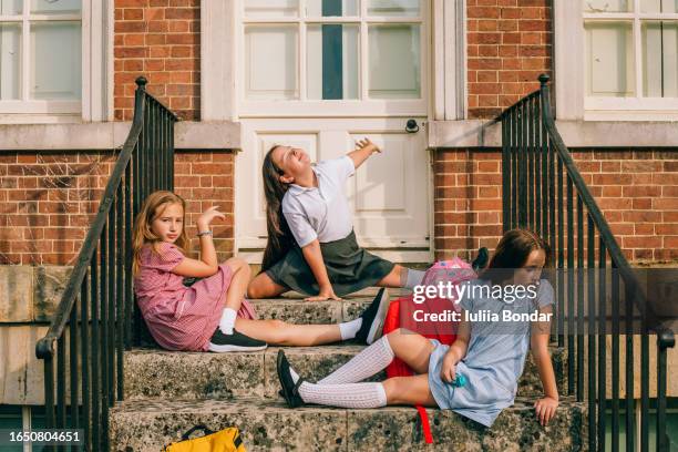 elementary school girls on stairs having fun - school building stock pictures, royalty-free photos & images