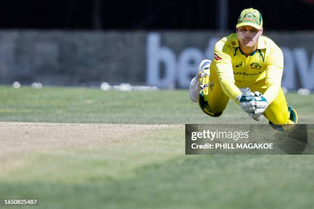 Australia's Alex Carey catches the ball dismissing South Africa's Aiden Markram during the first one-day international cricket match between South...