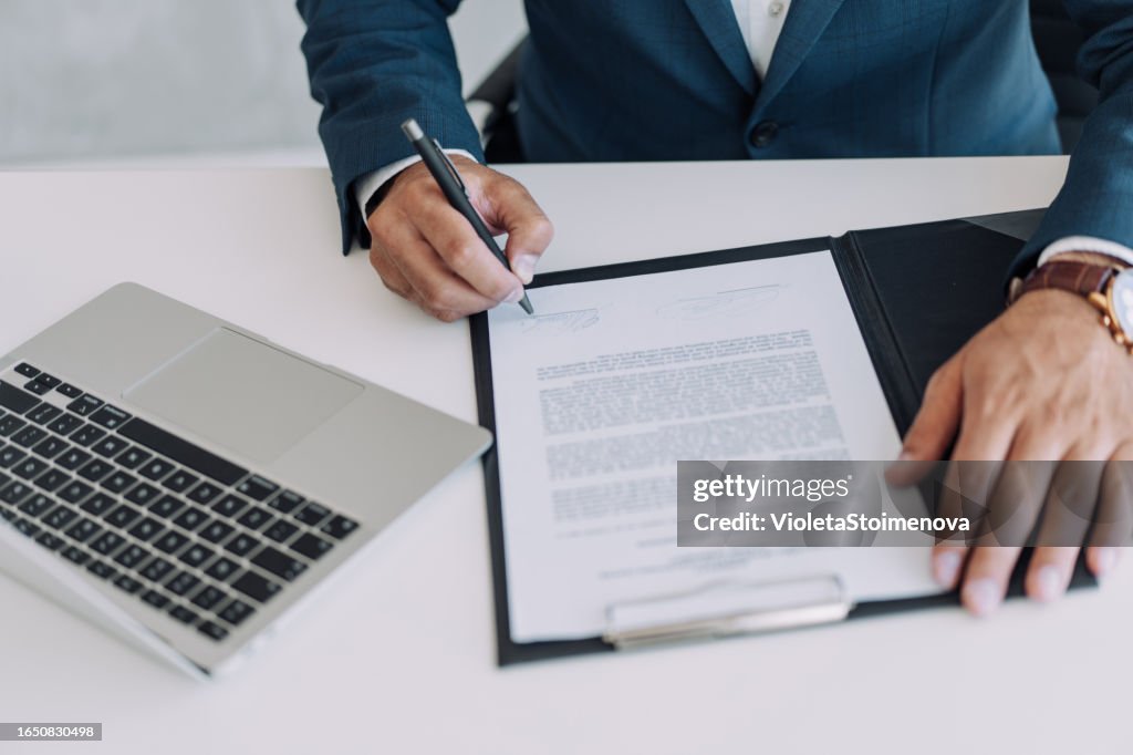 Businessman checking agreement before signing.