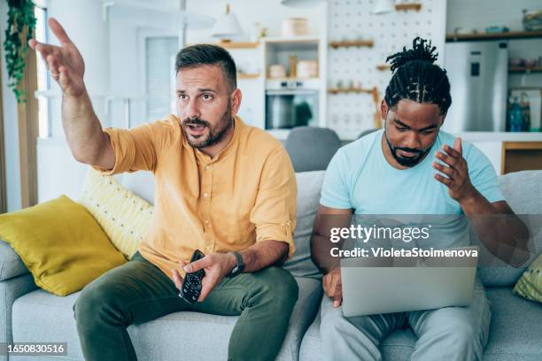 two friends watching sport event on tv. - gambling loss stock pictures, royalty-free photos & images