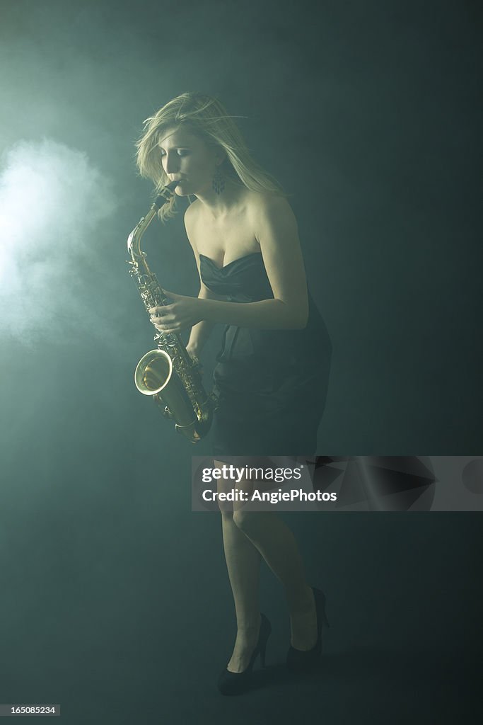 Beautiful woman playing saxophone