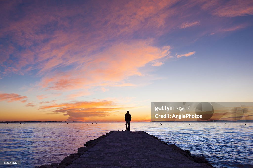 Man standing on jetty