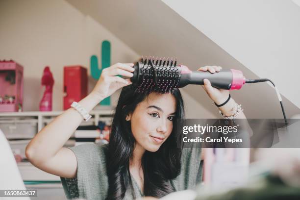 young woman combing her hair - brush in woman's hair imagens e fotografias de stock