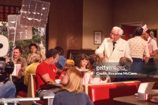 Colonel Harland David Sanders who founded the fast food restaurant chain Kentucky Fried Chicken and who is wearing a white suit, a Kentucky Colonel...