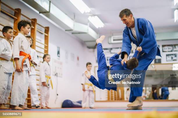 kids having a judo training session - jujitsu stock pictures, royalty-free photos & images