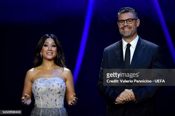 Pedro Pinto and Reshmin Chowdhury, UEFA Champions League Draw Presenters speak to the audience during the UEFA Champions League 2023/24 Group Stage...