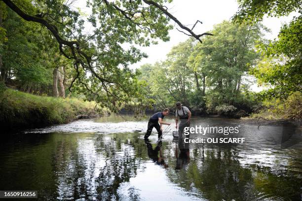 Chris West, a Project Officer with the West Cumbria Rivers Trust, and Simon Johnson , the Executive Director of the Freshwater Biological...