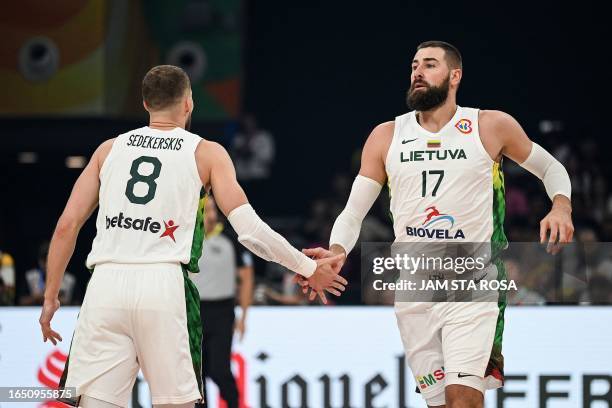 Lithuania's Jonas Valanciunas and Tadas Sedekerskis gestures during the FIBA Basketball World Cup classification match between Slovenia and Lithuania...