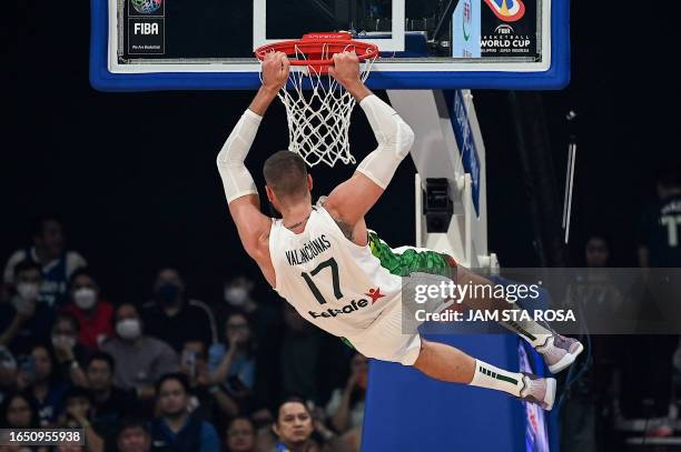 Lithuania's Jonas Valanciunas dunks the ball during the FIBA Basketball World Cup classification match between Slovenia and Lithuania in Manila on...