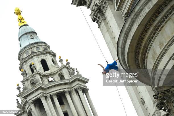 Bandaloop perform "RESURGAM" outside St Paul's Cathedral launching the City of London’s Bartholomew Fair on August 31, 2023 in London, England.