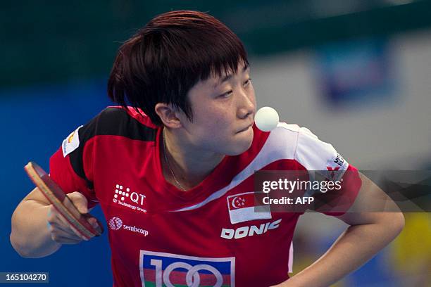 Feng Tianwei of Singapore returns a shot during her match against Fukuhara Ai of Japan at the World Team Classic Table Tennis game in Guangzhou, east...