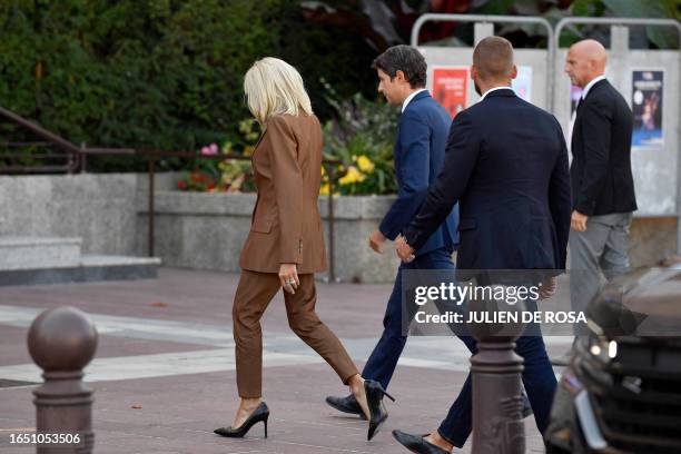 French President's wife Brigitte Macron and Education minister Gabriel Attal arrive on September 7, 2023 at the Paris suburban city of Poissy's city...