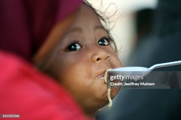 Filipino Muslim child, displaced by continuing armed conflict between the supporters of Philippine Muslim clan Sulu Sultan Jamalul Kiram III and...