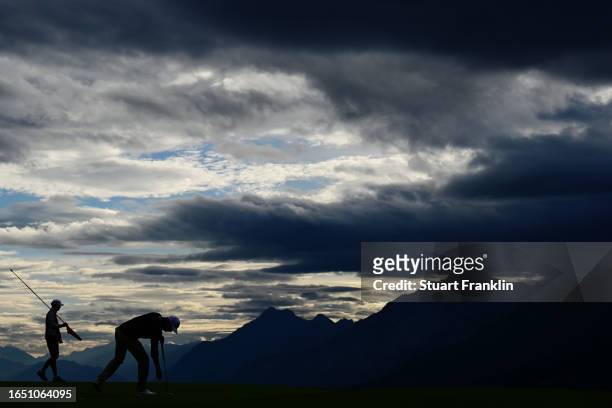 Christoffer Bring of Denmark collects his ball from the hole on the 7th green during Day One of the Omega European Masters at Crans-sur-Sierre Golf...