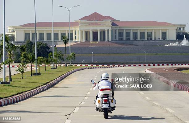 Police motorcycle approaches the President's Office prior to Myanmar President Thein Sein hosting US Secretary of State Hillary Clinton for a meeting...