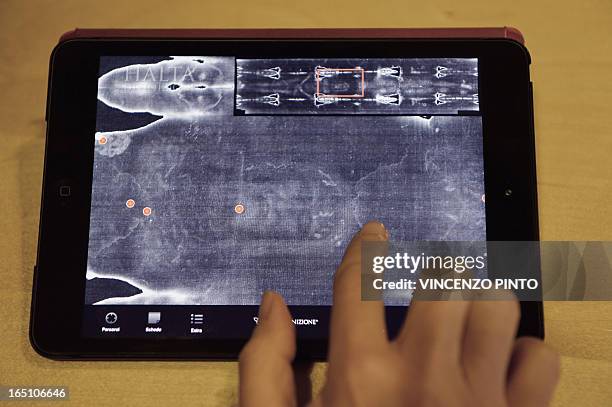 Picture taken on March 30, 2013 in Rome shows a screen displaying "The Shroud of Turin" with the Shroud 2.0 app. On Good Friday, a Piedmont company,...