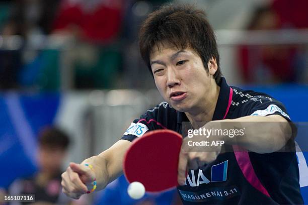 Jun Mizutani of Japan returns to a shot during his match against Xu Xin of China at the World Team Classic Table Tennis game in Guangzhou, in east...