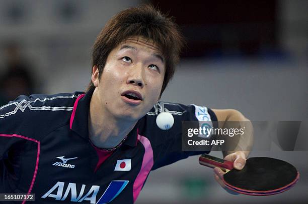 Jun Mizutani of Japan serves during his match against Xu Xin of China at the World Team Classic Table Tennis game in Guangzhou, east China's...